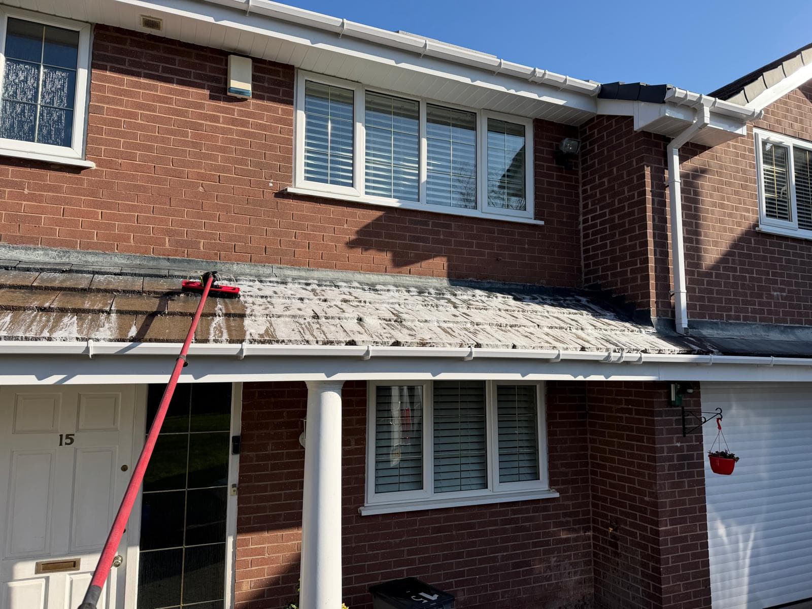 Soft wash foam treatment applied to roof tiles